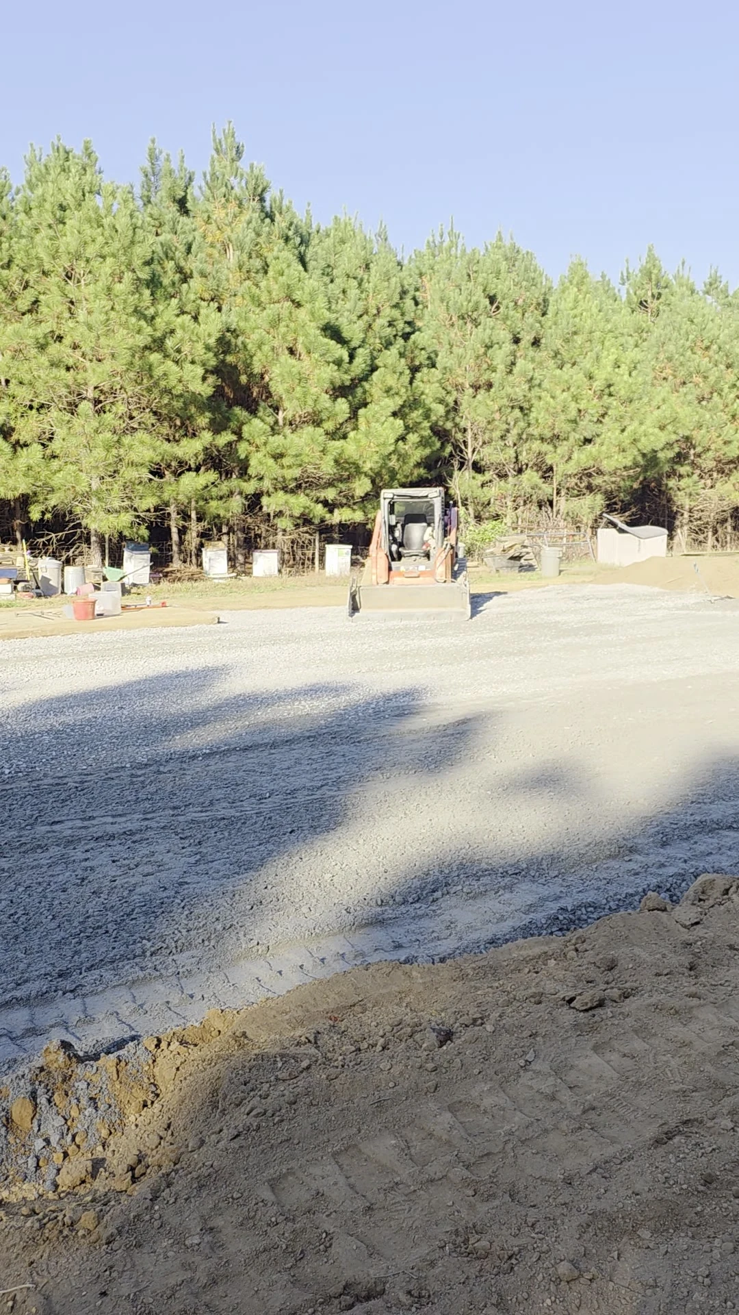 Spread gravel and a skid steer at the Chesterfield dry-lot project.